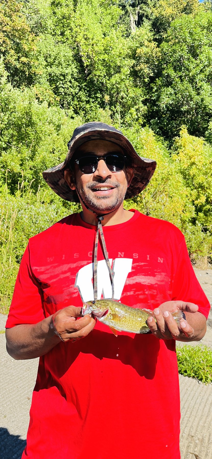 A Smallmouth Bass held in hand during field sampling on an Oregon river.